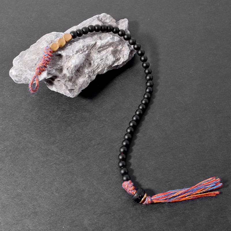 Braccialetto fatto a mano in onice nero tibetano con nappa Buddha Stones - Image 6